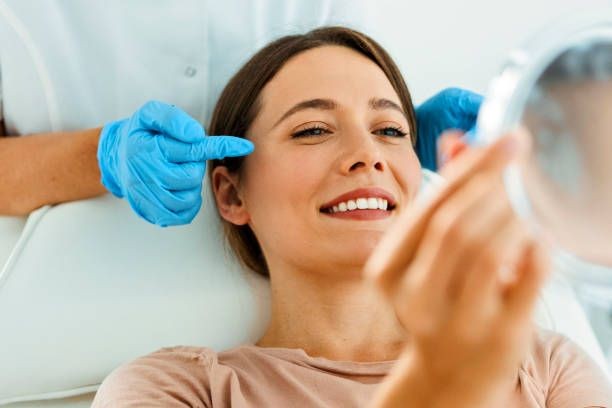Image that focuses in detail on the face of a woman who is being guided by a specialist for the facial rejuvenation process.