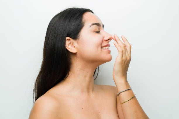 An image where you can see a young woman who has undergone a successful rhinoplasty attended by a certified cosmetic surgeon.